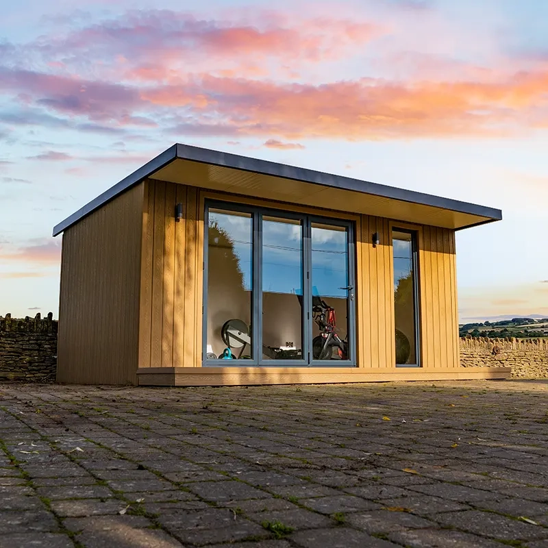 A Nexus Garden Room half lit up by the sun with a beautiful sunrise in the background