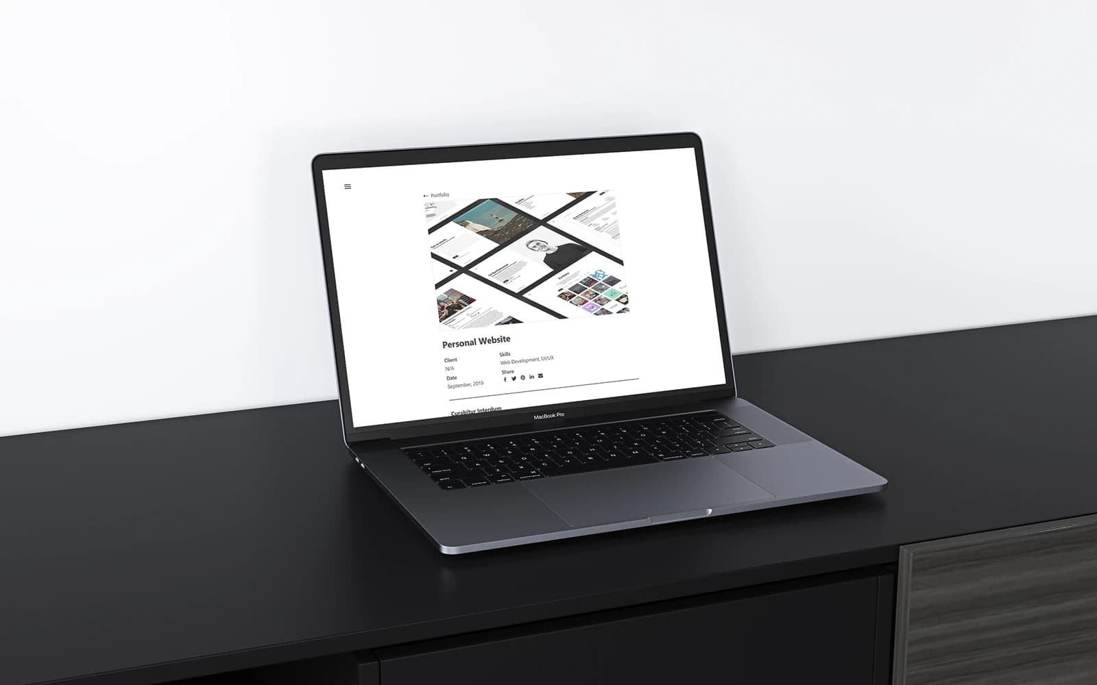 A laptop on a black desk displaying an example of a project page from the Ed Bartholomew website