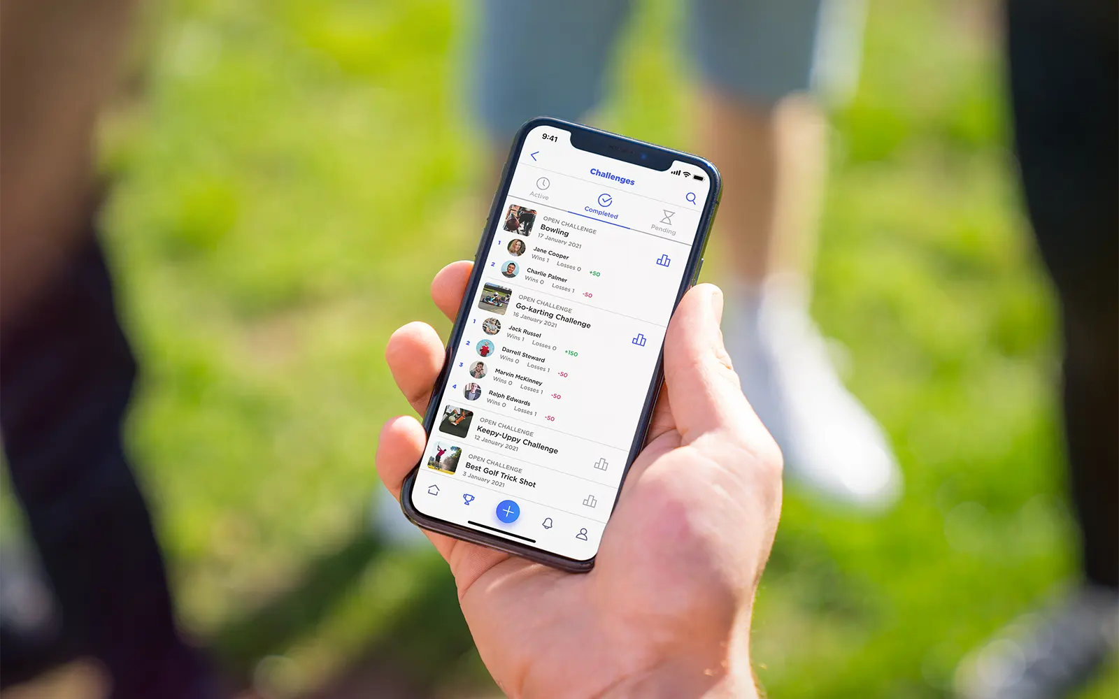 A close up of a smart phone showing the my challenges page from the Challenge Social app