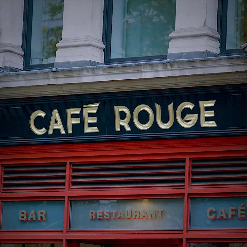 A still from a promotional video showing the Cafe Rouge logo above the entrance of it’s St Paul’s restaurant