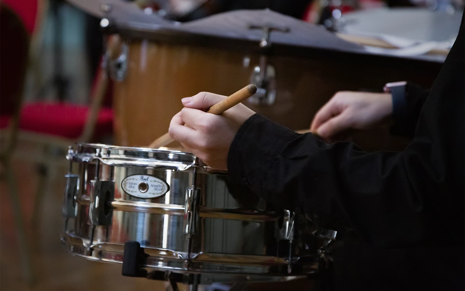 Close up of drum being played during an orchestral concert