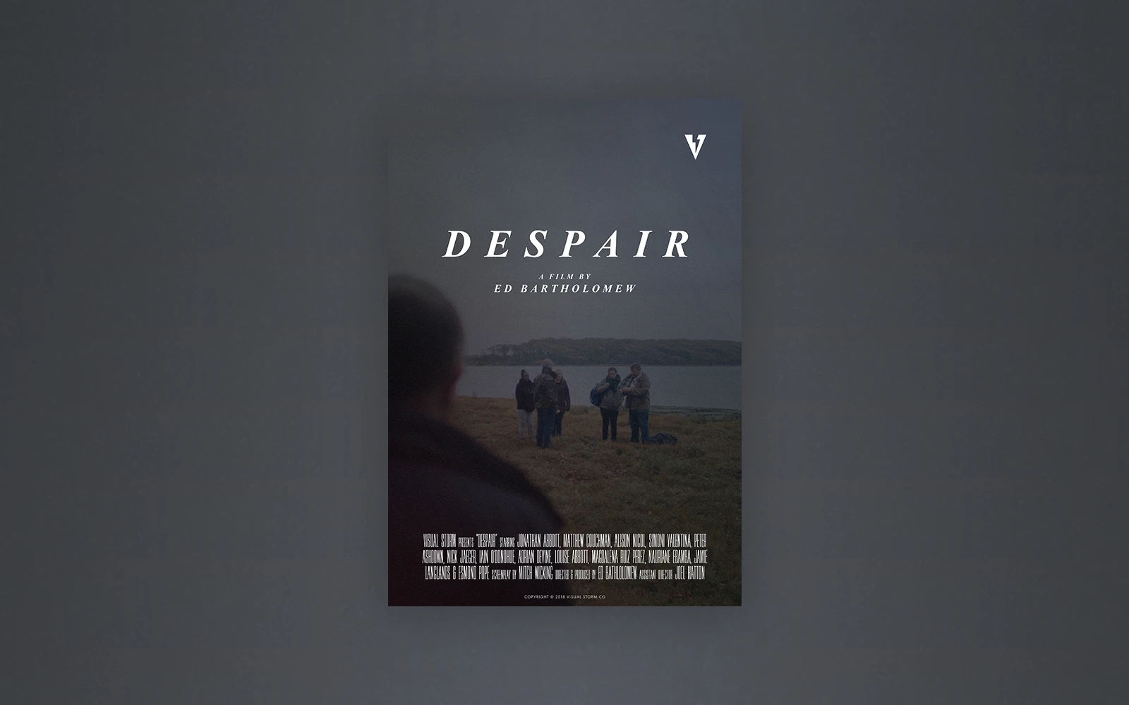 A promotional poster for the short film ‘Despair’. The back of a man is seen looking forward to the beach with immigrants arriving on a gloomy autumn day
