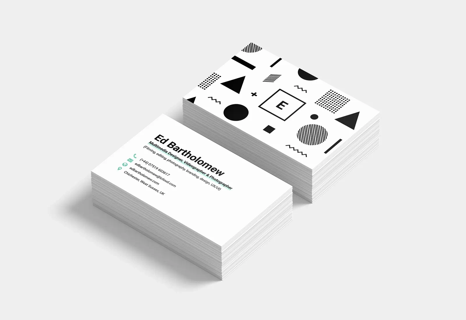 Both the back and the front of the Ed Bartholomew business cards are displayed at a slight angle. The front shows the brand’s logo, surrounded by a variety of shapes in black and white. In a similar design to the website, the back displays my contact information in a clean and modern style